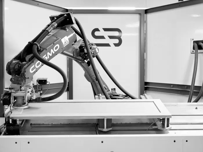 Robotic sander finishing a five-piece door on the line