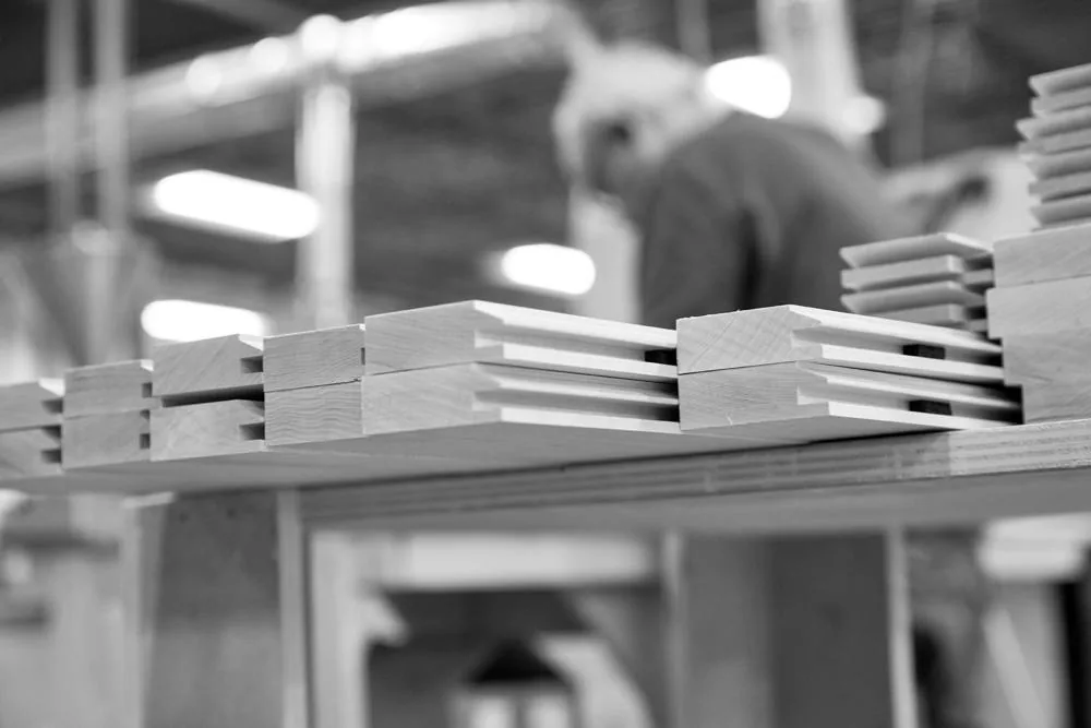 A stack of finished door parts ready to ship